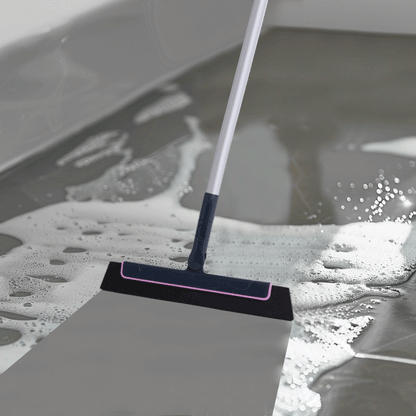 Floor squeegee pushing water across a wet floor