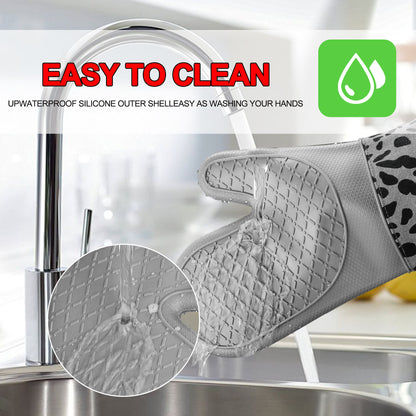 Rinsing a grey silicone oven mitt clean under the kitchen tap
