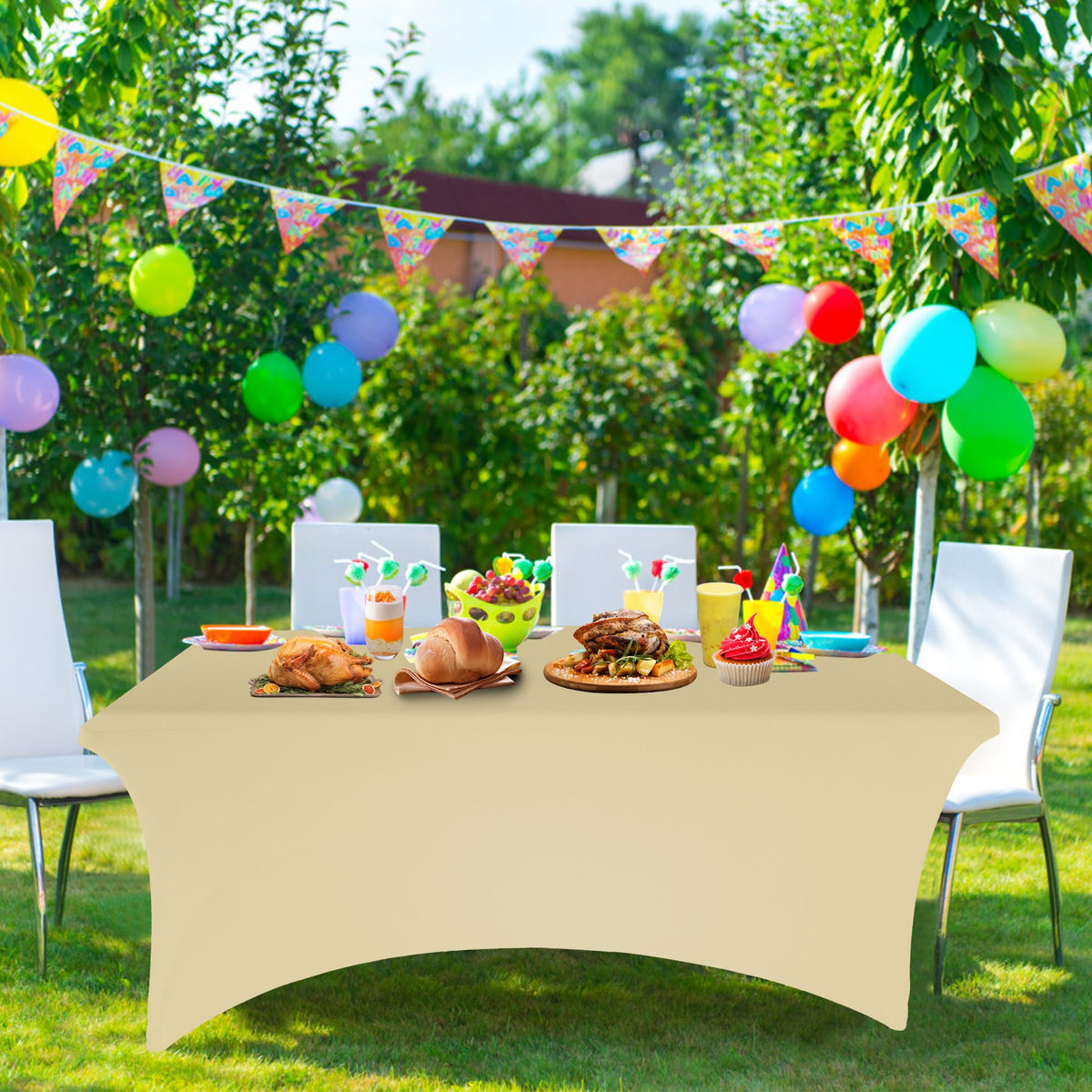 Champagne stretch tablecloth on a trestle table at a garden party